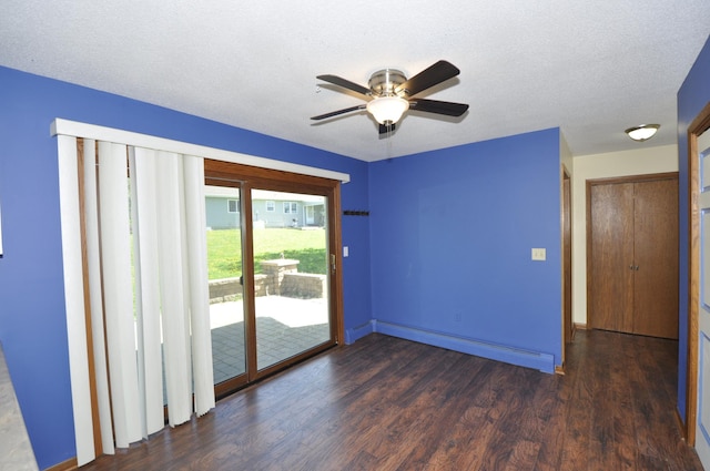 spare room with wood finished floors, a ceiling fan, a baseboard heating unit, baseboards, and a textured ceiling