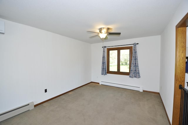 spare room with a baseboard heating unit, a baseboard radiator, carpet, ceiling fan, and baseboards