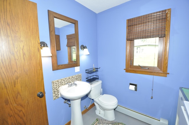 half bathroom featuring a baseboard radiator and toilet