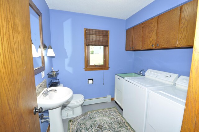 bathroom featuring separate washer and dryer, toilet, and a baseboard heating unit