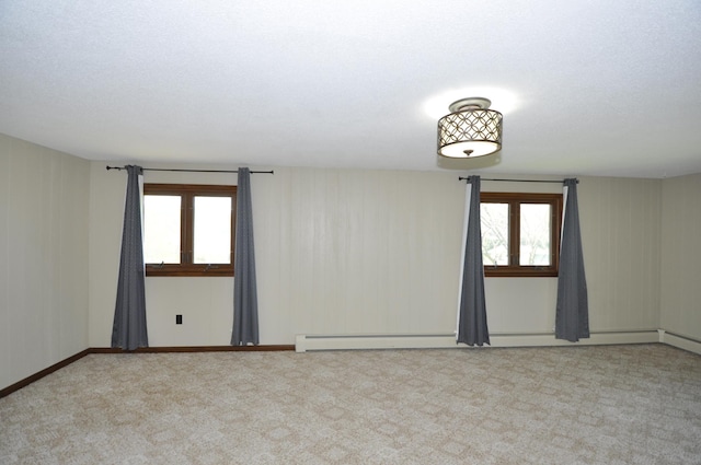 spare room featuring carpet floors and baseboard heating