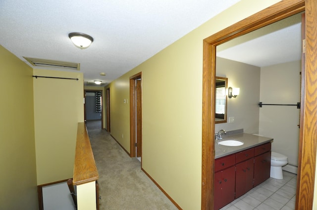 corridor with a baseboard radiator and a sink