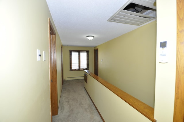hall featuring light colored carpet, visible vents, and a baseboard heating unit