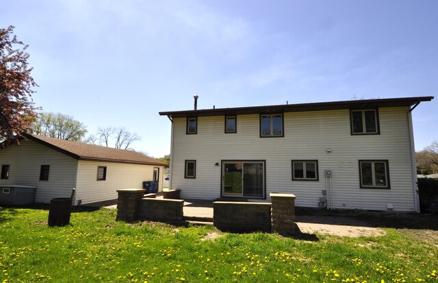 back of house with a lawn