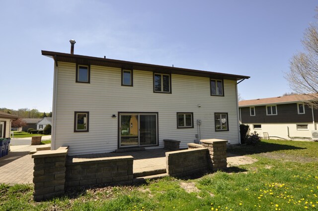 rear view of house with a yard and a patio area