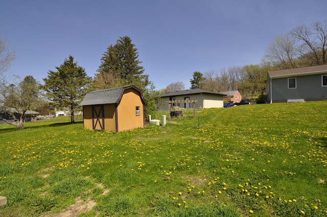 view of grassy yard featuring a shed and an outdoor structure