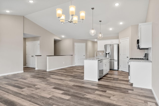 kitchen featuring stainless steel refrigerator with ice dispenser, a sink, dishwashing machine, baseboards, and white cabinets