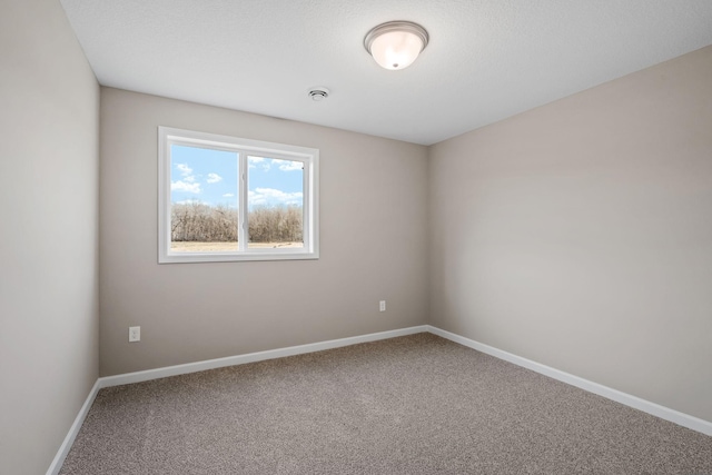 unfurnished room featuring carpet flooring and baseboards