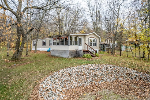 29501 Maplewood Rd Autumn, Unit Autumn, Callaway, MN 56521 - manufactured / mobile home featuring a sunroom and a front yard