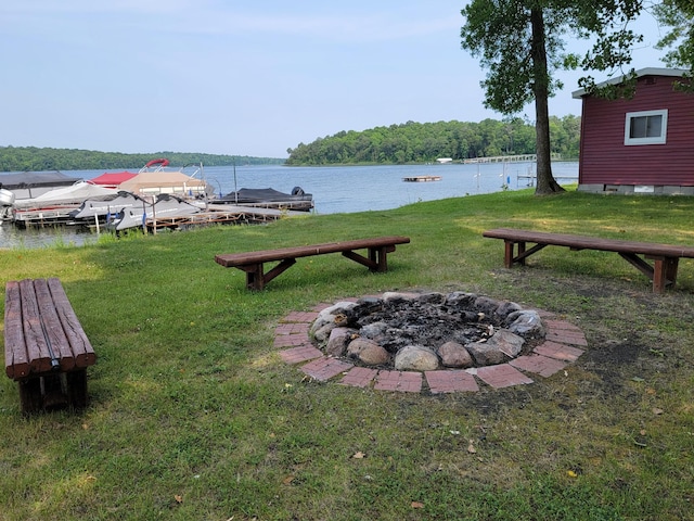 29501 Maplewood Rd Autumn, Unit Autumn, Callaway, MN 56521 - view of green lawn with an outdoor fire pit and a water view