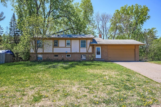 4209 81st Ave N, Brooklyn Park, MN 55443 - view of front of house with brick siding, a garage, a front yard, and driveway