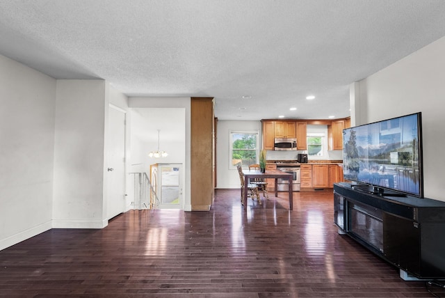 4209 81st Ave N, Brooklyn Park, MN 55443 - living room featuring dark wood-style floors, a textured ceiling, baseboards, a chandelier, and recessed lighting