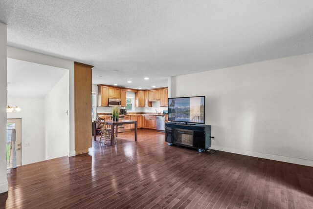 4209 81st Ave N, Brooklyn Park, MN 55443 - living area with dark wood-type flooring, recessed lighting, baseboards, and a chandelier