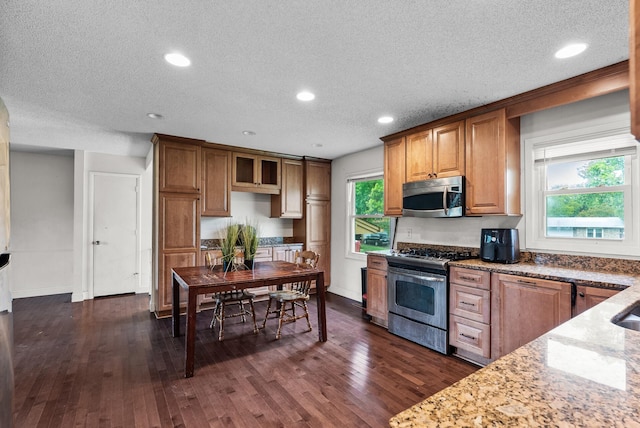 4209 81st Ave N, Brooklyn Park, MN 55443 - kitchen with stainless steel appliances, a textured ceiling, dark wood finished floors, light stone counters, and recessed lighting