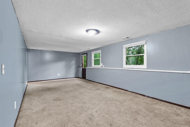 4209 81st Ave N, Brooklyn Park, MN 55443 - empty room featuring a textured ceiling, carpet floors, and baseboards