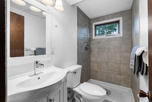 4209 81st Ave N, Brooklyn Park, MN 55443 - bathroom with tiled shower, toilet, and vanity