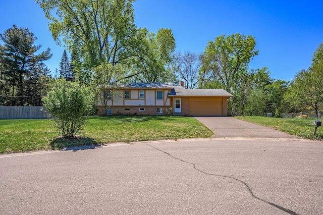 4209 81st Ave N, Brooklyn Park, MN 55443 - view of front of property with brick siding, an attached garage, driveway, and a chimney