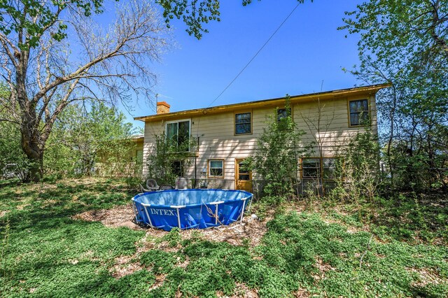 4209 81st Ave N, Brooklyn Park, MN 55443 - back of property featuring a chimney and an outdoor pool