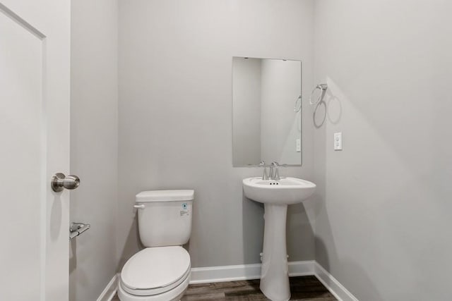 2466 Jandell Ave NE, Saint Michael, MN 55376 - bathroom with wood finished floors, toilet, baseboards, and a sink