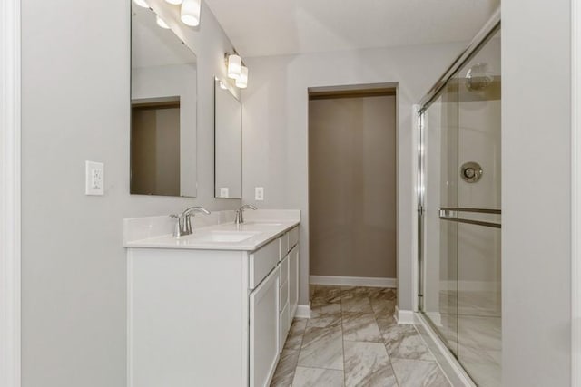 2466 Jandell Ave NE, Saint Michael, MN 55376 - bathroom with marble finish floors, a stall shower, double vanity, and baseboards