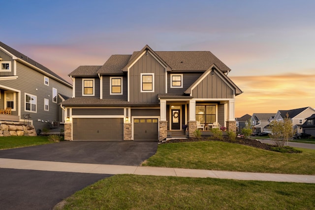 9769 Iron Horse Rd, Woodbury, MN 55129 - view of front of home featuring board and batten siding, a garage, asphalt driveway, and stone siding