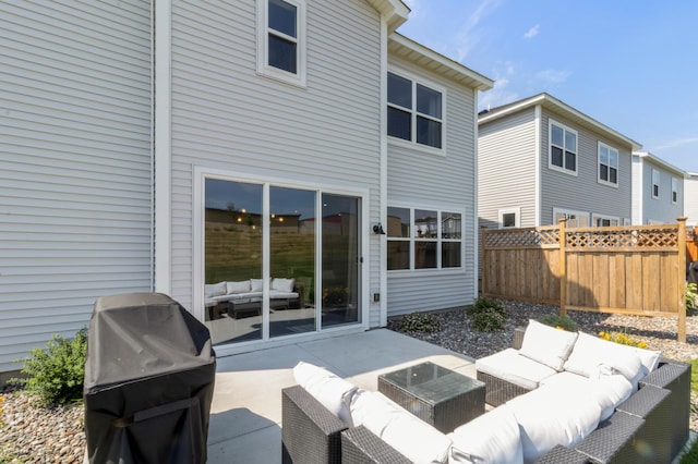 back of property with outdoor lounge area, fence, and a patio area