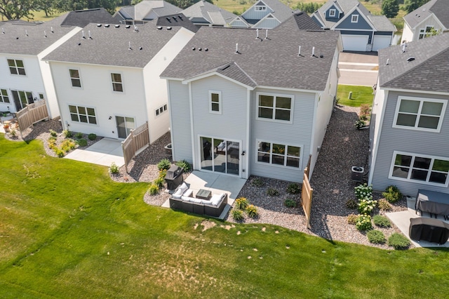 back of property with a patio area, an outdoor living space, a residential view, and a shingled roof