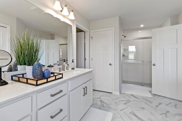 bathroom featuring a stall shower, marble finish flooring, vanity, and recessed lighting