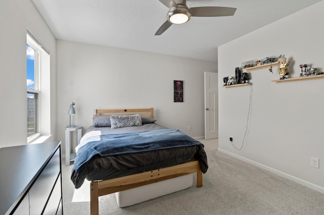 bedroom featuring multiple windows, carpet, baseboards, and ceiling fan
