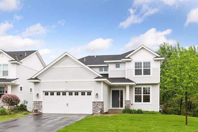 19124 63rd Ave N, Corcoran, MN 55340 - view of front of property featuring asphalt driveway, stone siding, an attached garage, and a front yard