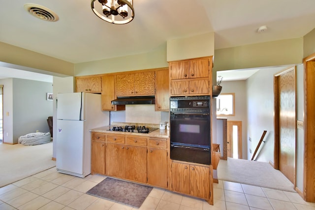 kitchen featuring visible vents, light tile patterned flooring, a warming drawer, black appliances, and light countertops