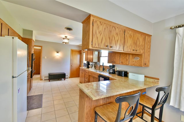 kitchen featuring a sink, a peninsula, a baseboard heating unit, freestanding refrigerator, and dishwashing machine
