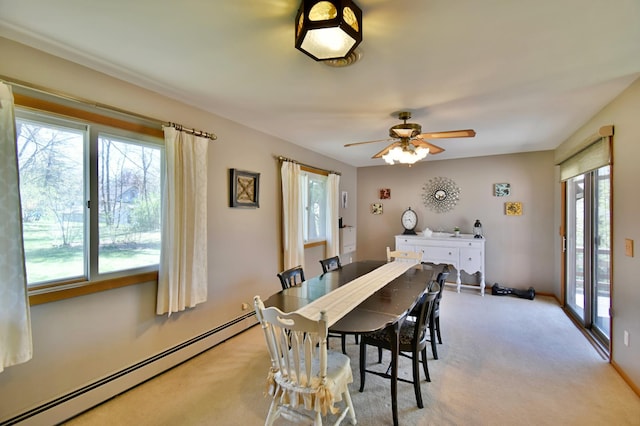 dining space featuring light colored carpet, plenty of natural light, and baseboard heating