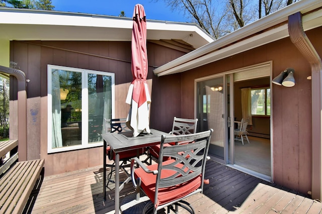 wooden deck featuring a baseboard heating unit