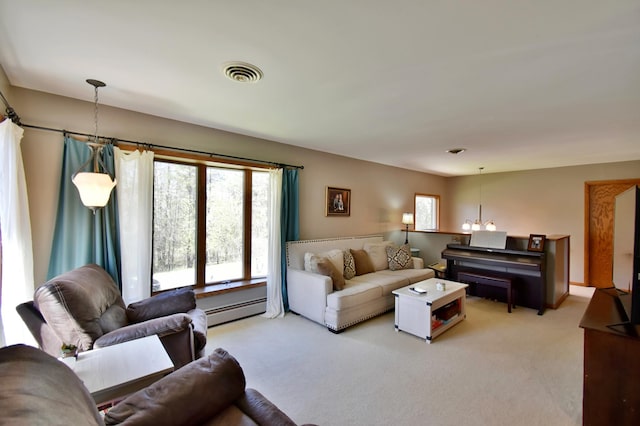 living area featuring visible vents, a baseboard radiator, and light carpet