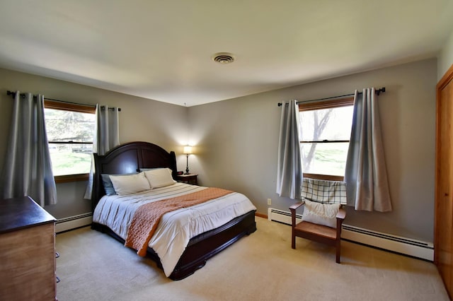bedroom featuring visible vents, baseboards, a baseboard radiator, and light carpet