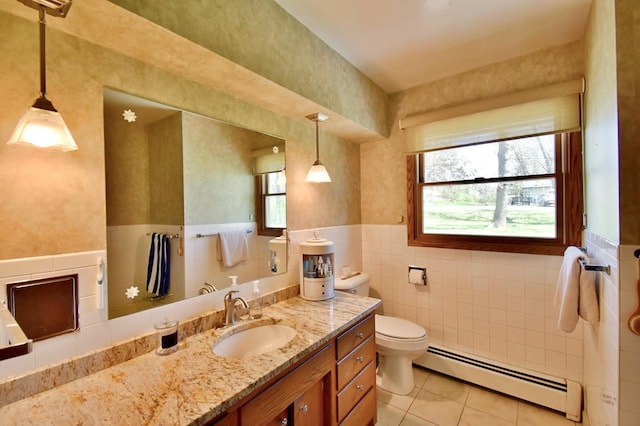 bathroom with tile walls, toilet, a baseboard heating unit, tile patterned flooring, and wainscoting