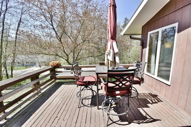 wooden deck featuring outdoor dining area