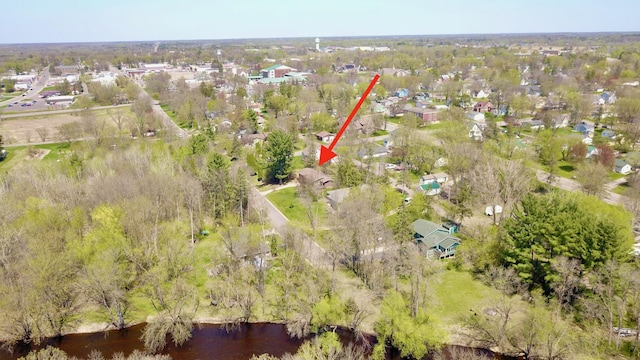 drone / aerial view with a water view and a residential view