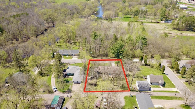 drone / aerial view with a water view and a residential view