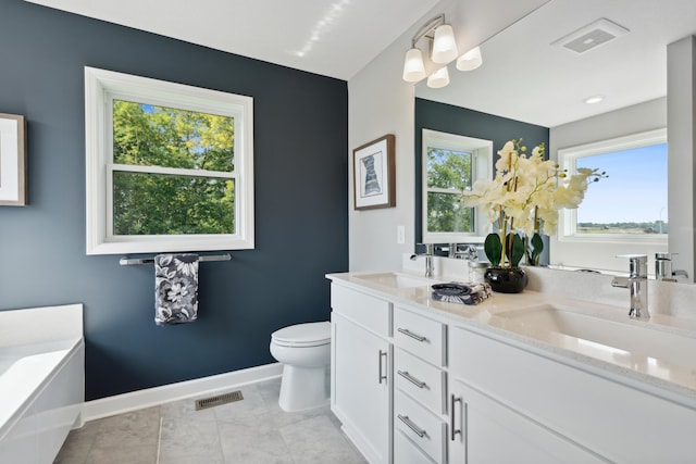 15056 Sycamore St NW, Andover, MN 55304 - full bathroom featuring healthy amount of natural light, toilet, baseboards, and double vanity