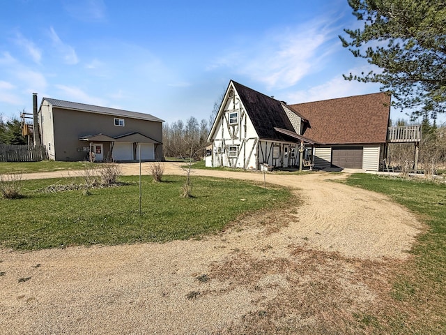 view of home's exterior with driveway and a lawn