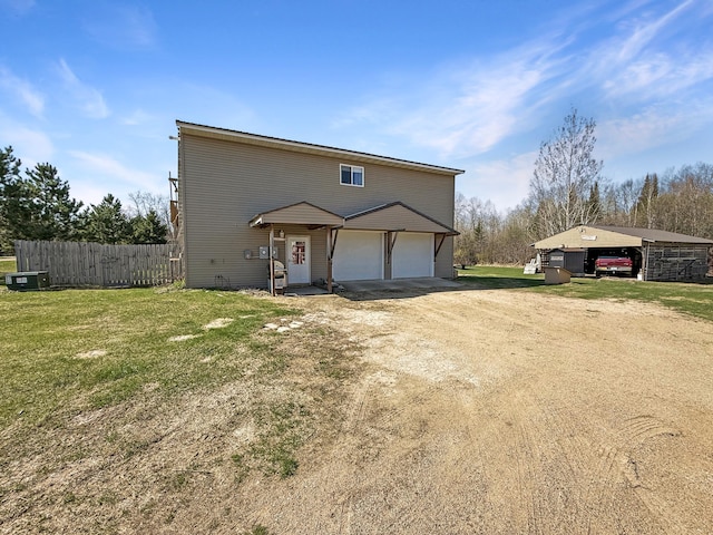 view of front facade featuring a garage and dirt driveway