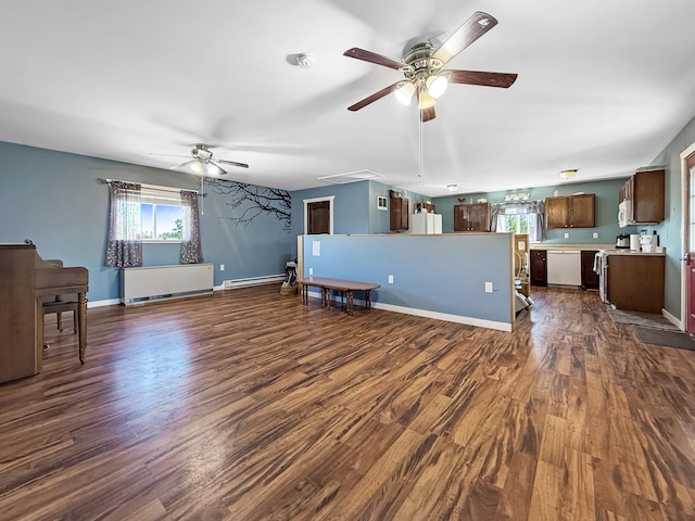 unfurnished living room with ceiling fan, dark wood-style floors, a baseboard heating unit, and baseboards
