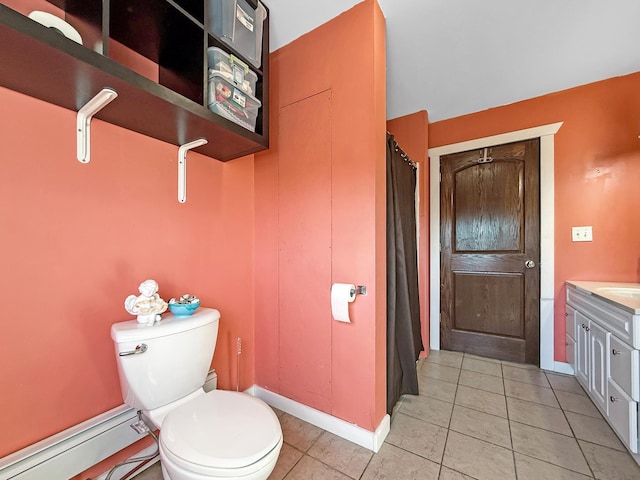 full bath featuring baseboards, toilet, vanity, and tile patterned floors