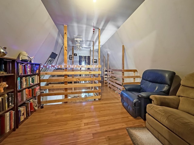 living area with wood finished floors and a ceiling fan