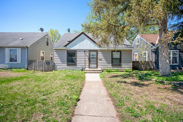 5748 25th Ave S, Minneapolis, MN 55417 - bungalow-style house with fence, a shingled roof, and a front lawn