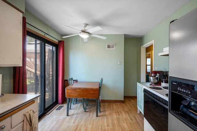 5748 25th Ave S, Minneapolis, MN 55417 - kitchen featuring stainless steel refrigerator with ice dispenser, visible vents, under cabinet range hood, light wood-style flooring, and white electric stove