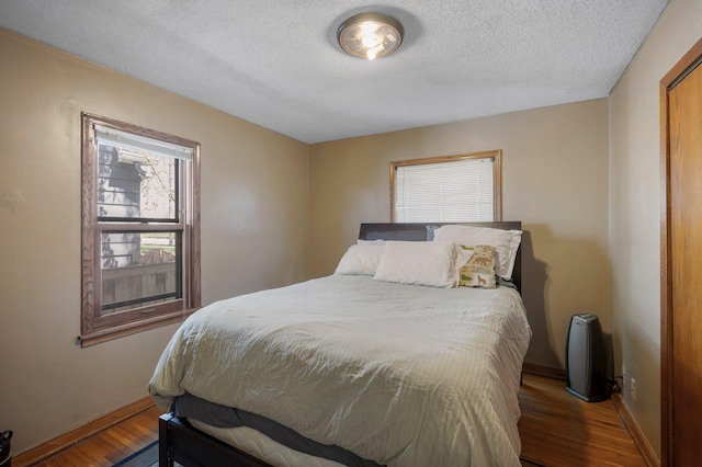 5748 25th Ave S, Minneapolis, MN 55417 - bedroom with a textured ceiling, baseboards, and wood finished floors