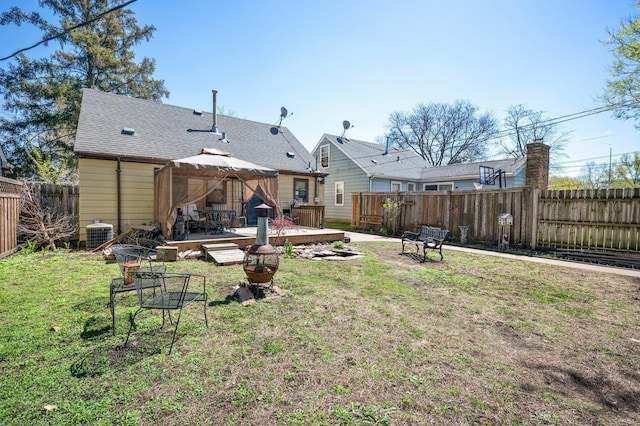 5748 25th Ave S, Minneapolis, MN 55417 - back of property with an outdoor fire pit, a wooden deck, a lawn, a gazebo, and a fenced backyard